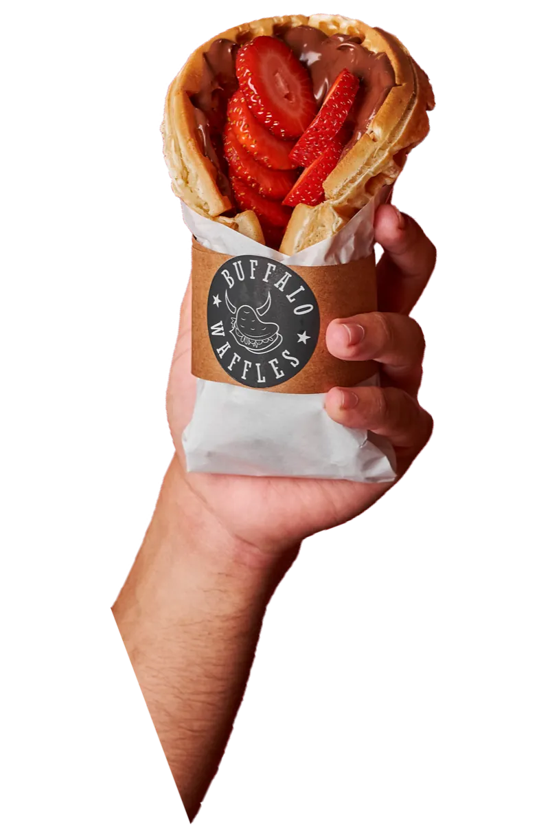 Mano sosteniendo un waffle Frutella con frutillas